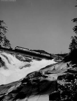 Great Northern westbound freight train above Sunset Falls, east of Index, Washington with Boeing ...