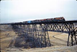 Great Northern Railway train 88 with General Electric Class U25B on bridge at Cutbank, Montana in...