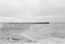 Four Southern Pacific Railroad diesel locomotives lead an extra freight east of Lovelock, Nevada ...