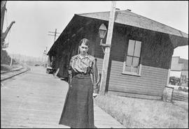 Woman at Northern Pacific station at Machias, Washington, circa 1920.