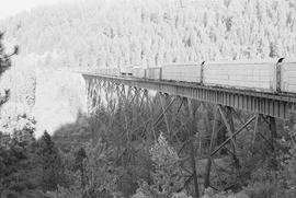 Chicago, Milwaukee, St. Paul & Pacific Railroad Company freight train on the bridge at Pedee,...