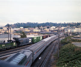 Burlington Northern diesel locomotive 2520 assist Amtrak power northbound away from Tacoma, Washi...